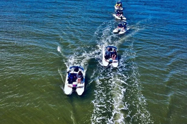 a group of people riding skis on a body of water