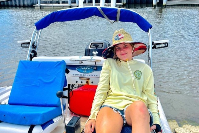 a boy sitting on a boat