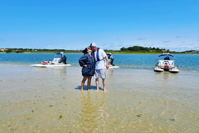 a group of people on a beach near a body of water