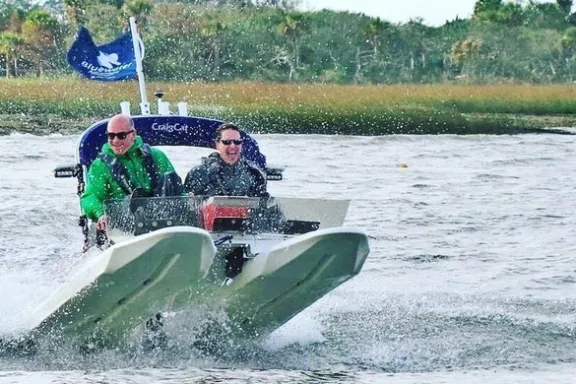 a man riding a surfboard on top of a body of water