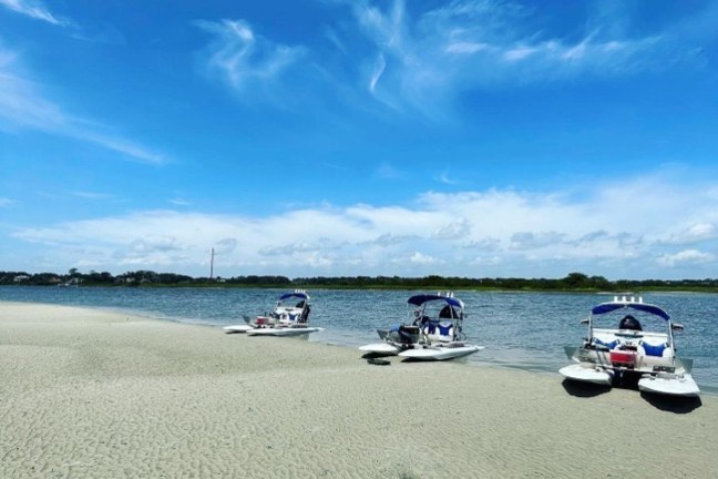 a boat sitting on top of a sandy beach