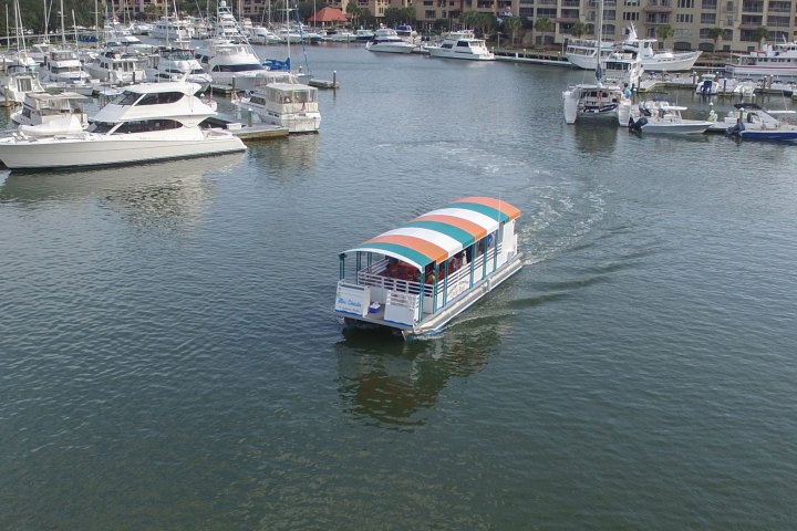 a small boat in a body of water with a city in the background