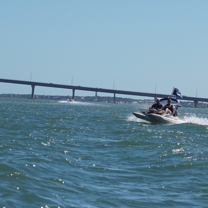 Catamaran with bridge in background