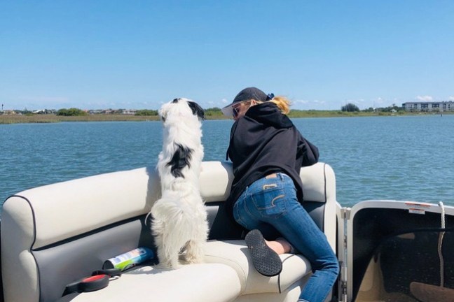 a woman sitting in a boat on a body of water