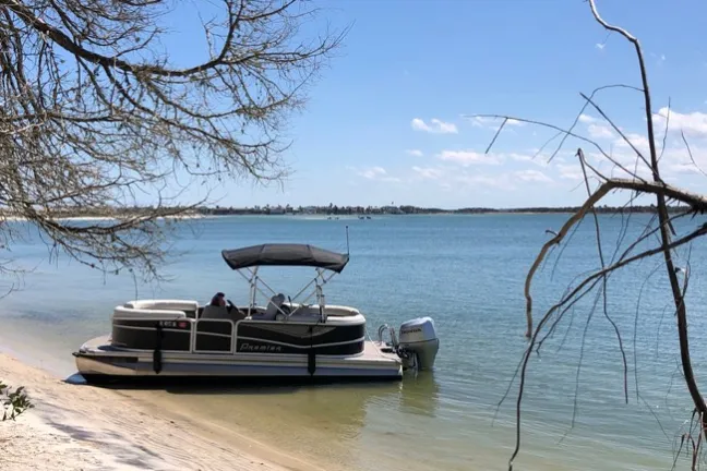 a boat sitting next to a body of water