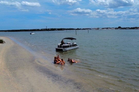 a group of people in a boat on a body of water