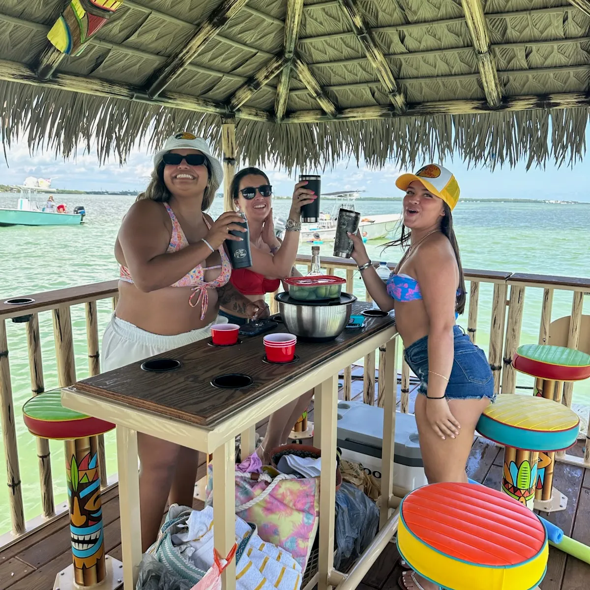 a group of people sitting at a table in front of a fence